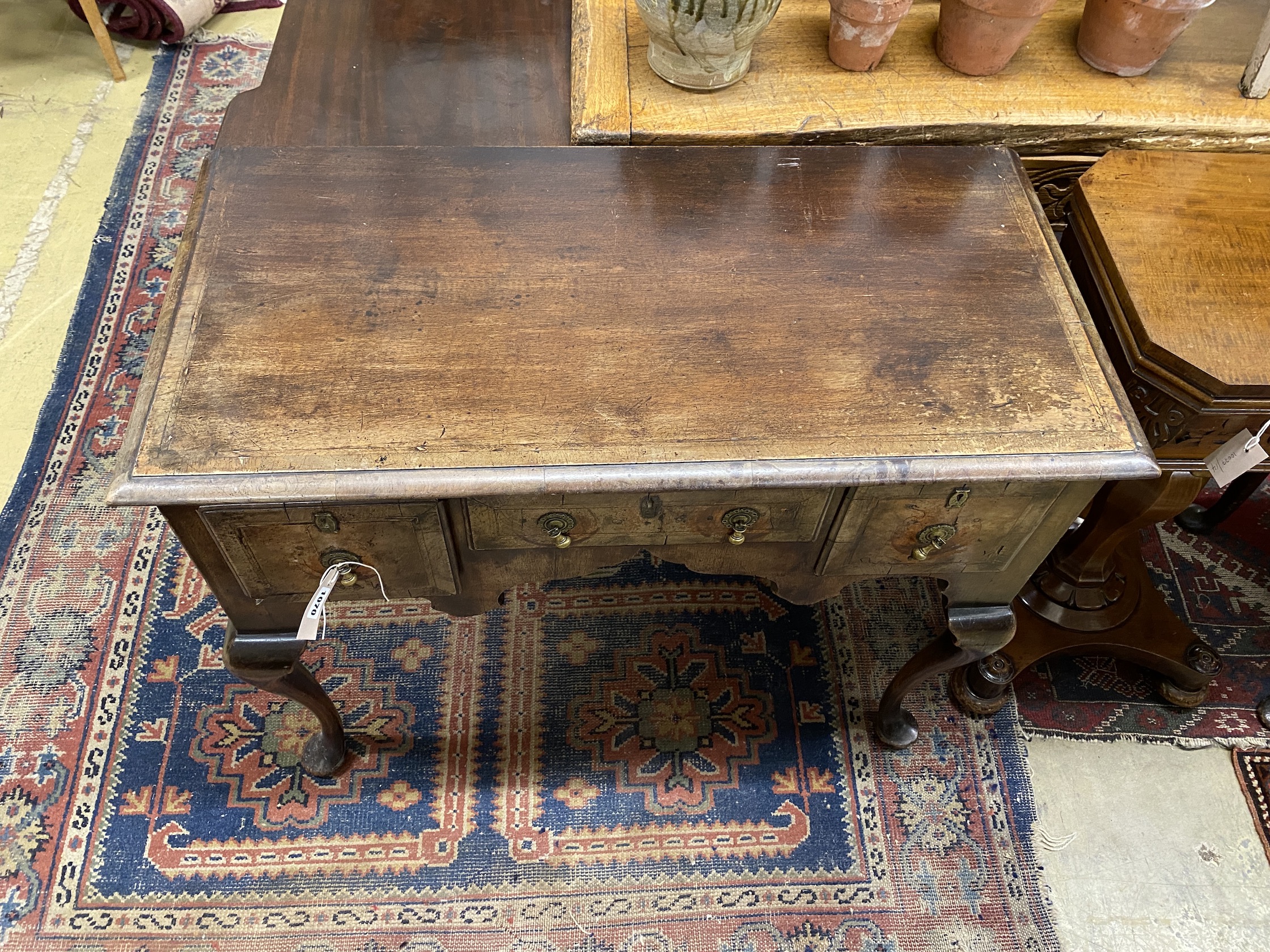 A Queen Anne style rectangular walnut kneehole table, width 92cm, depth 45cm, height 76cm